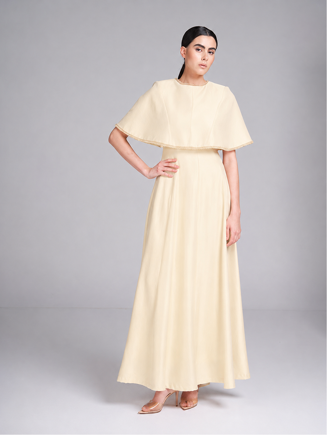 cape evening gown with beaded neckline and cape trim