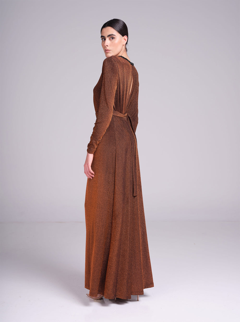 long sleeve evening gown with pleated waist and flowing maxi skirt