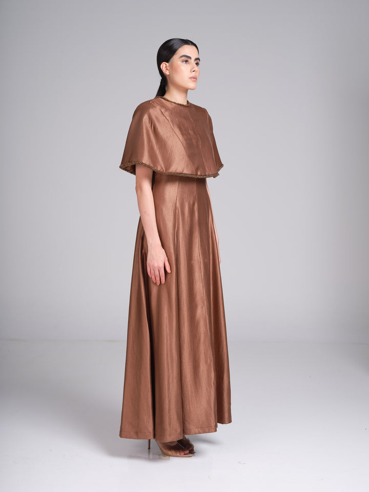 Bronze metallic cape evening gown with beaded neckline and cape trim