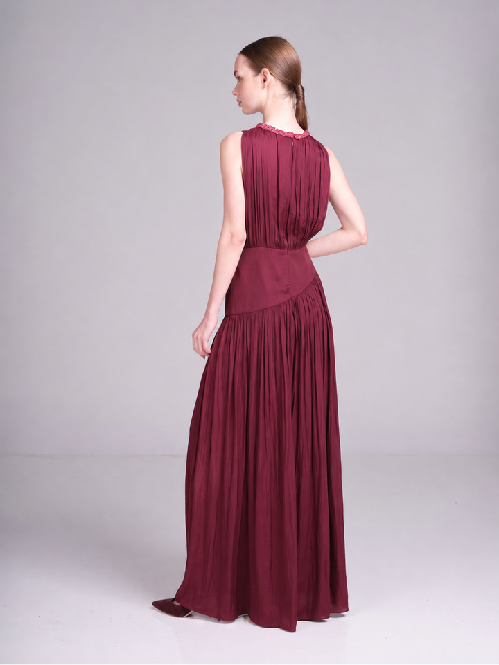 sleeveless maxi dress with asymmetric waist and flowing skirt