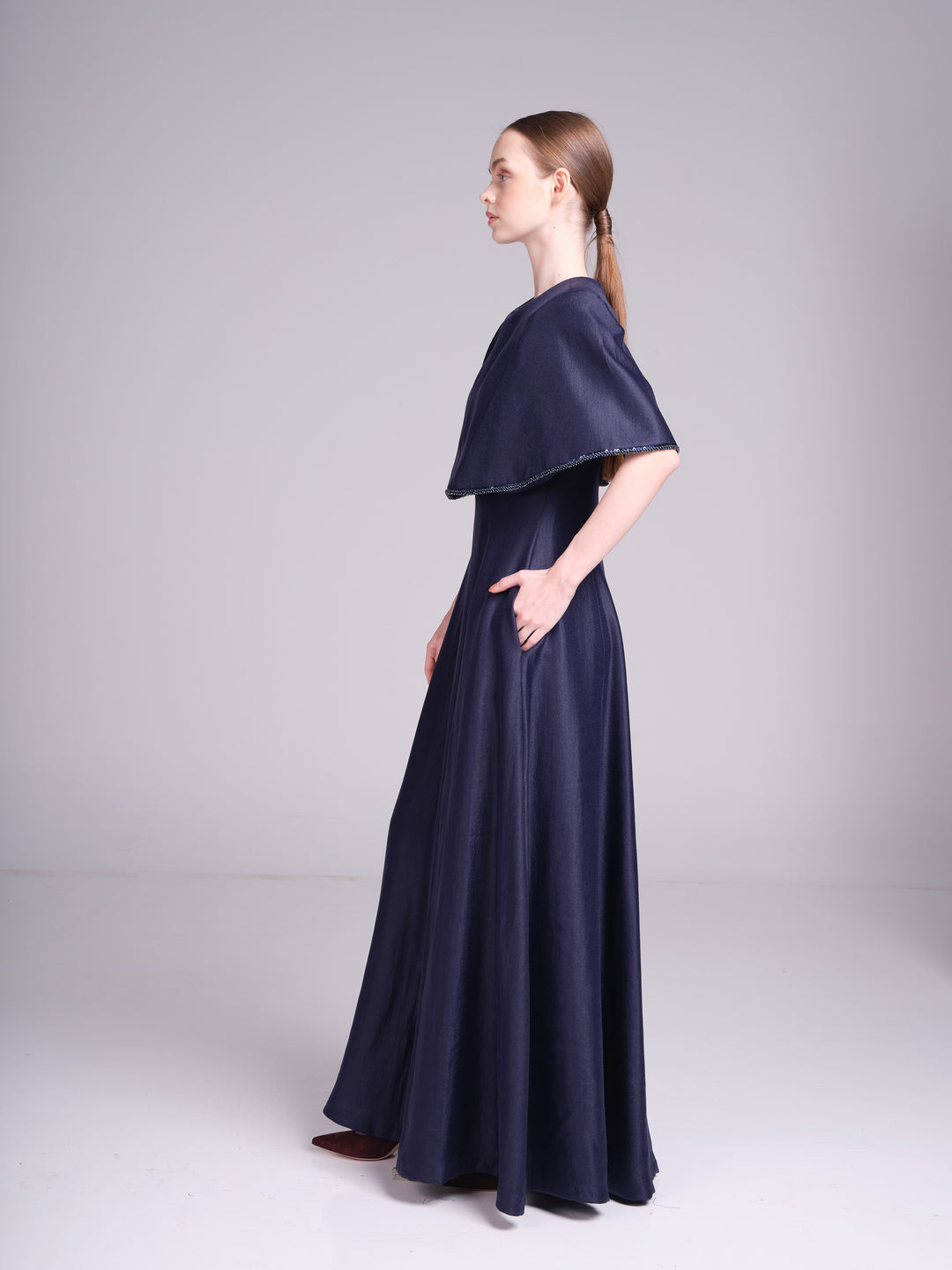 Alya navy blue wedding guest maxi dress with fitted waist and cape