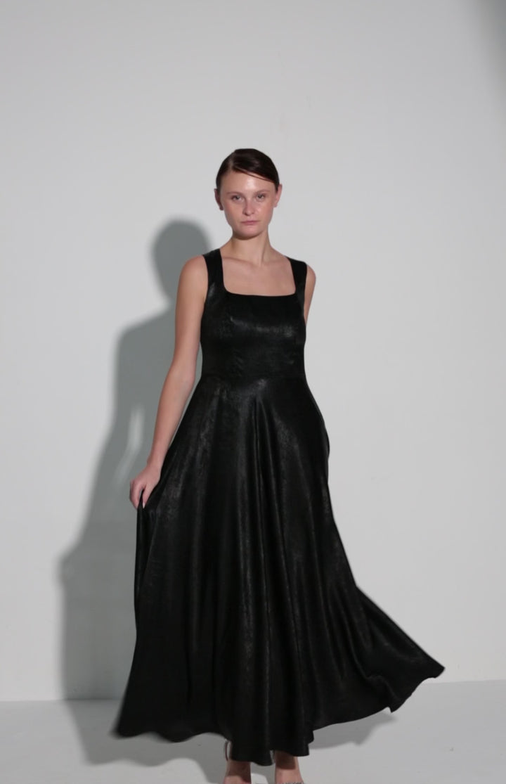 Video of the Monarda Dress in black, showing the flared skirt in movement as the model walks, by Baruni