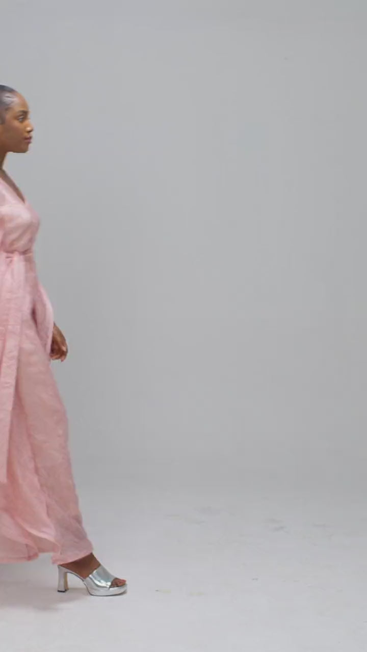 Pink organza kaftan moving to show the draped sides and the waist ties