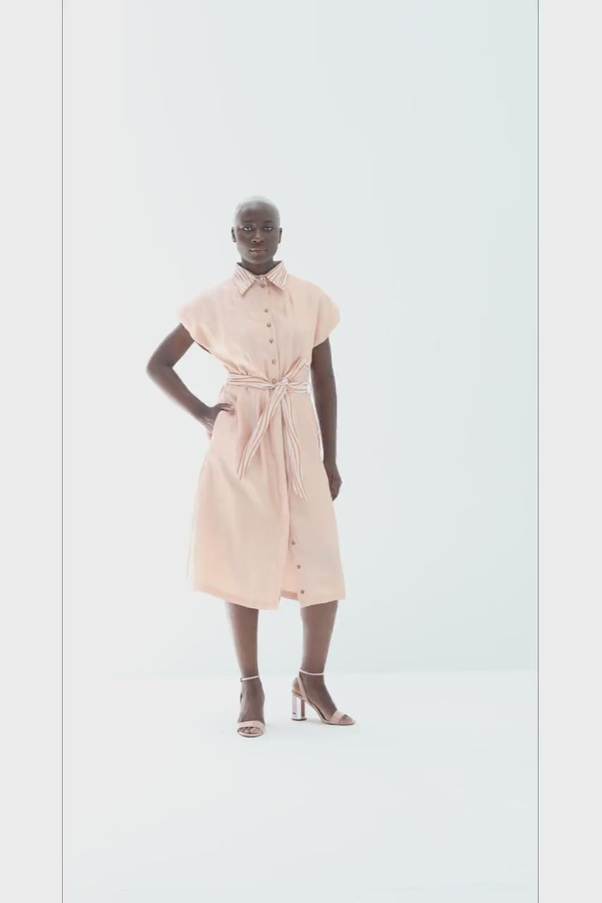 Video of the Adebola Dress in peach, showing the lurex collar, the tie and the skirt in movement, by Baruni