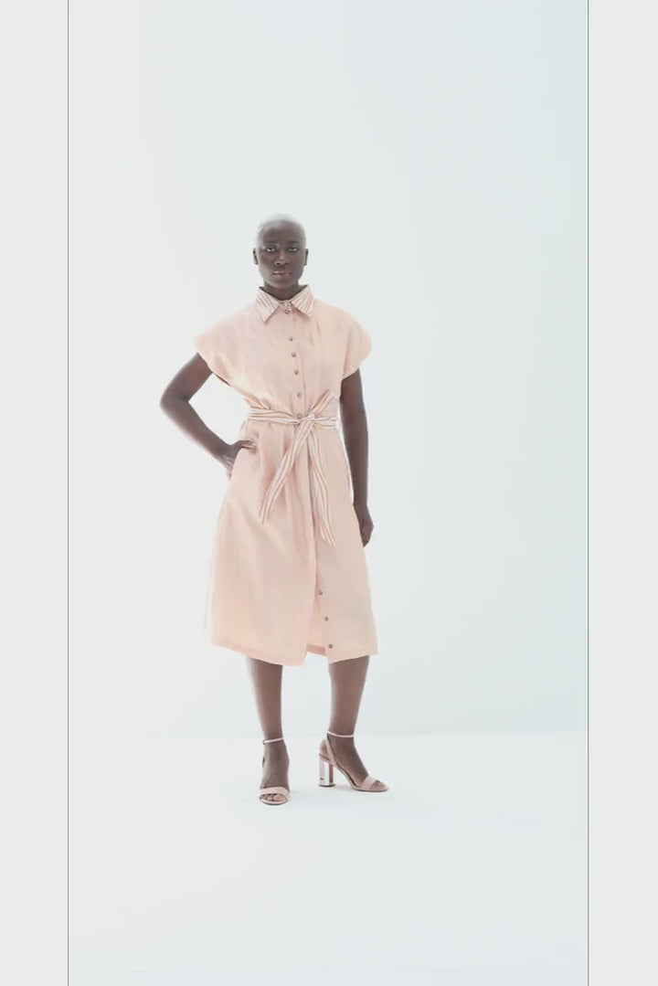Video of the Adebola Dress in peach, showing the lurex collar, the tie and the skirt in movement, by Baruni