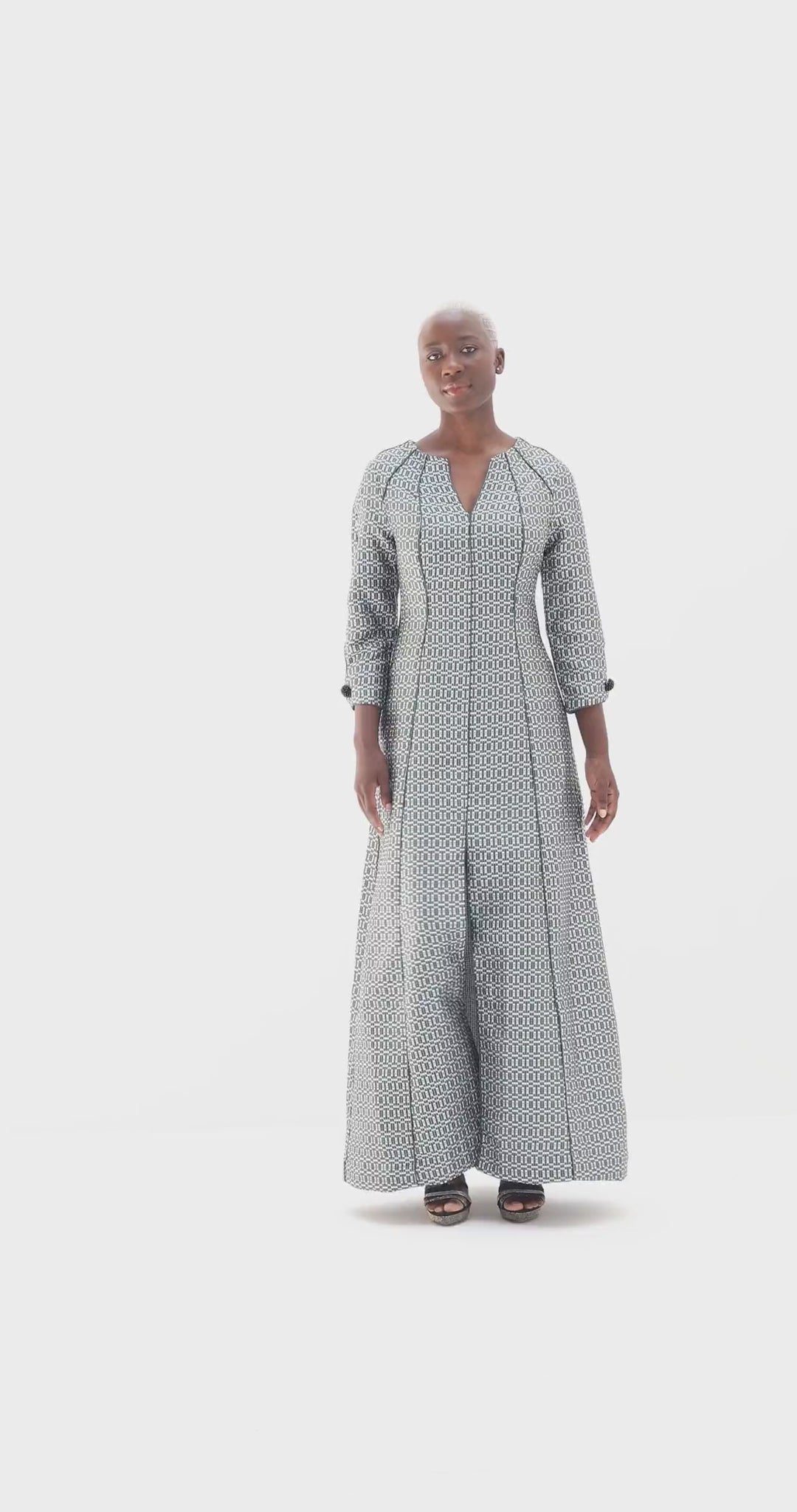 Model turning in a deep green jacquard maxi dress with a 40 cm front slit