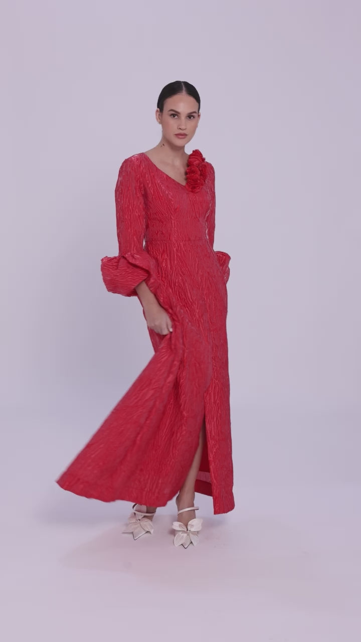 Elegant red formal gown with textured jacquard and dramatic sleeves