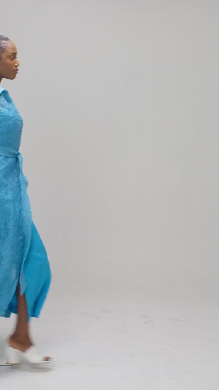 Turquoise organza jacket moving to show the inner dress side slits open