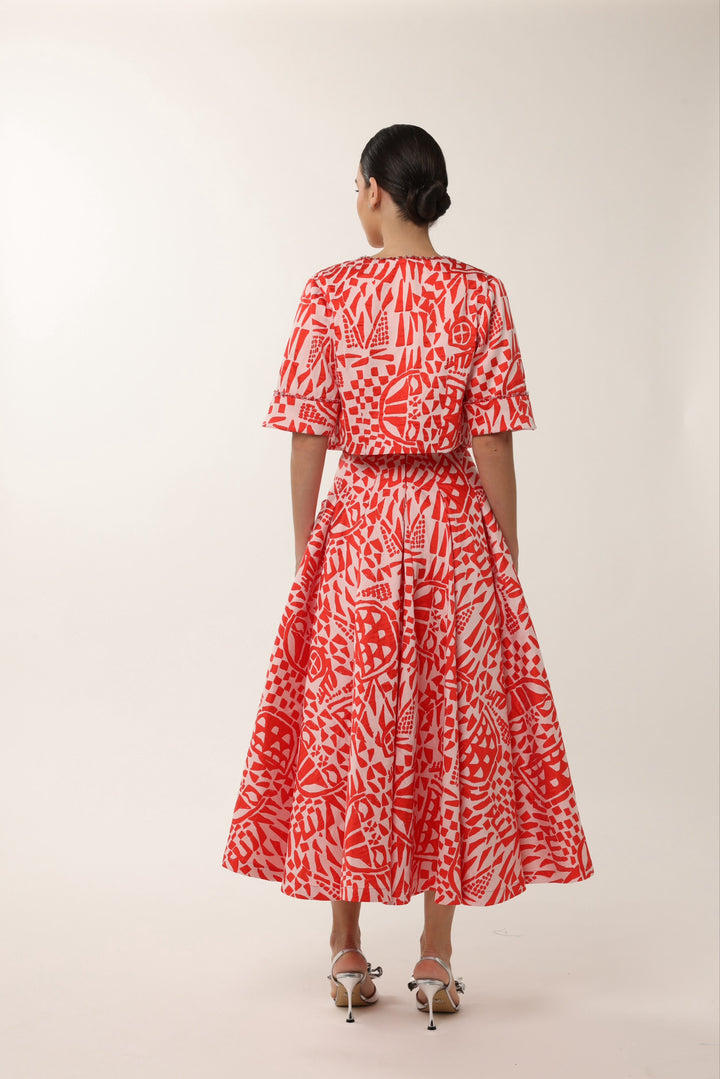 Elegant red wedding guest midi dress with beaded neckline